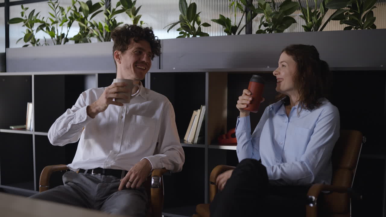 Two colleagues enjoying a coffee break in the office