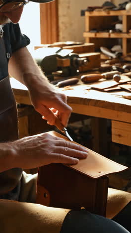 artisan handcrafting leather goods in a workshop