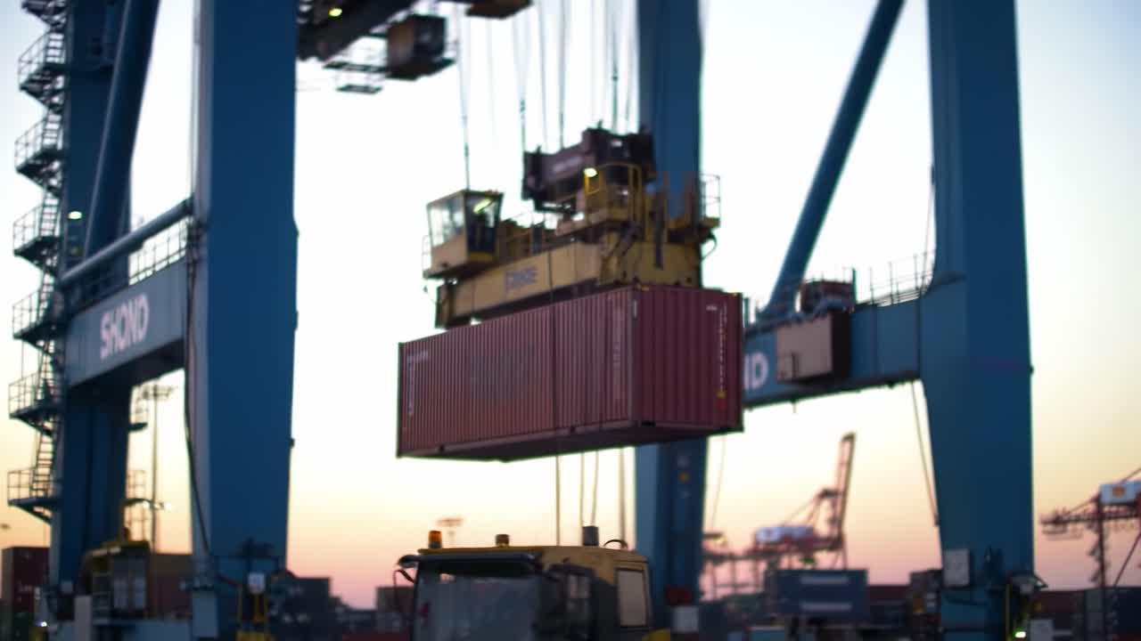 Large Crane Lifting Shipping Container at a Busy Port