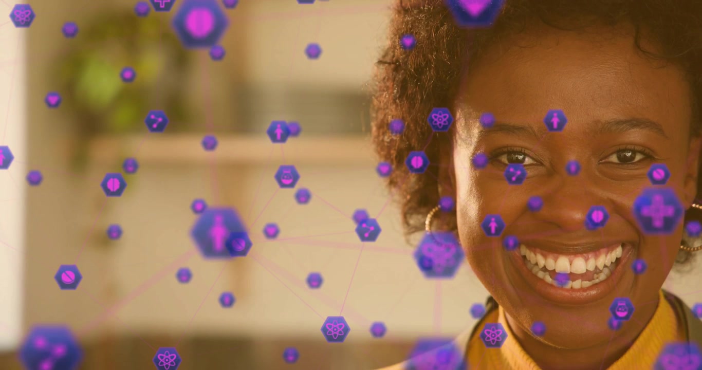 Mid adult woman initiating health visualization with purple hexagons swirling around face laughing