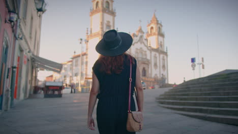 girl approaches church of mercy square in viseu portugal