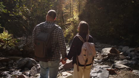 couple hiking in autumn forest