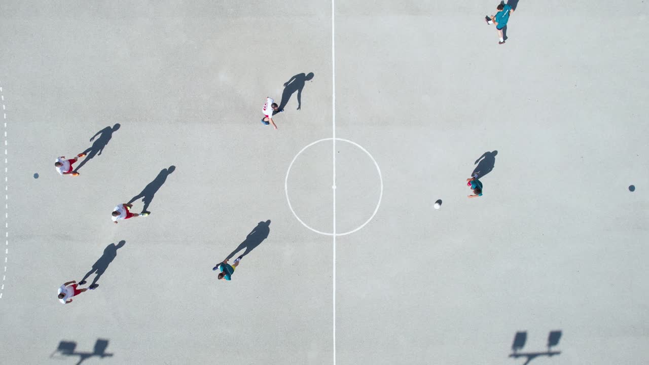 Top Down Aerial View of Men Playing Futsal on Outdoor Court, High Angle Drone Shot