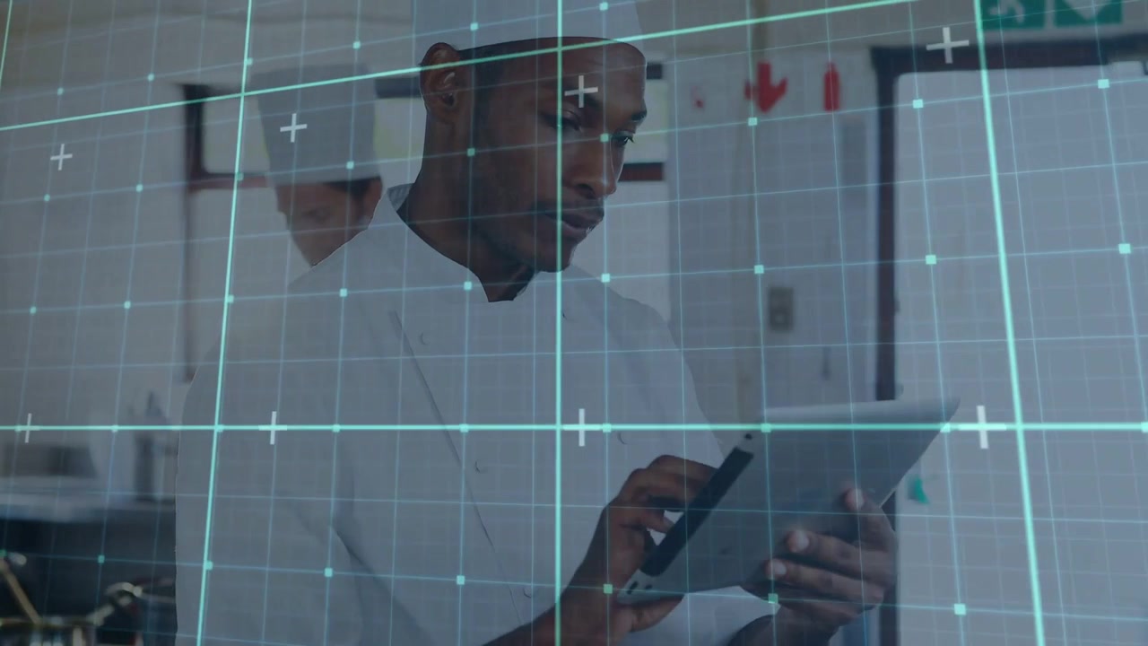 Male chef scrolling, tapping tablet in kitchen, checking orders, holographic grid overlaying frame