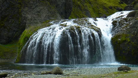 slow motion footage of small stjornarfoss waterfall in green canyon in south iceland