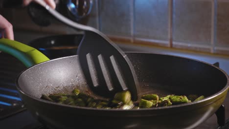 cooking and stirring asparagus with seasonings in a skillet, then pour eggs