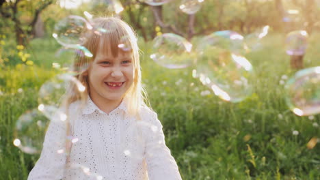 Carefree-Girl-Is-Catching-Soap-Bubbles-Cheerfully-A-Walk-In-The-Spring-Garden-Slow-Motion-Video