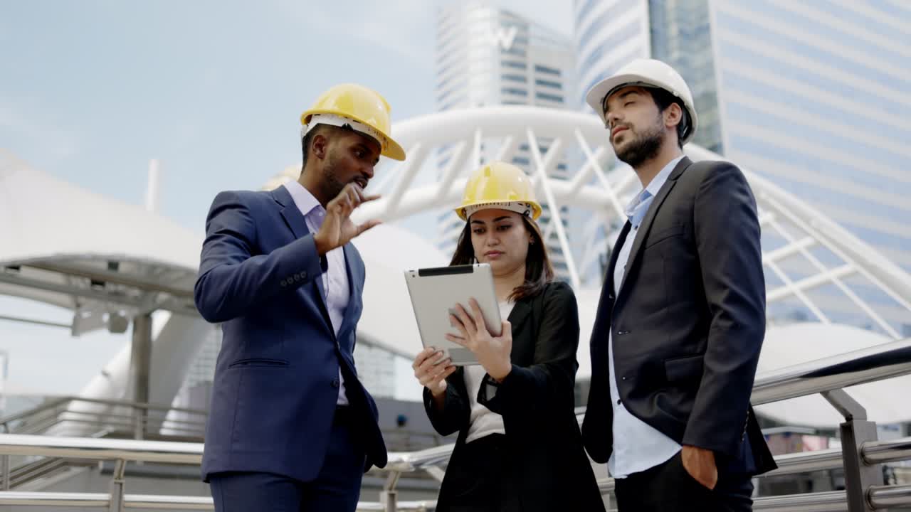 Businesspeople and architect have meeting to brainstorm ideas for city construction. Chief Civil Engineer consulting with team. Engineer team brainstorming on building design. Concept Blue collar