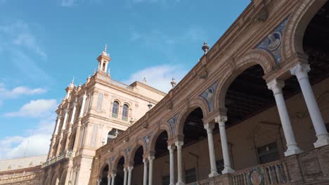 Architectural detail of Plaza de Espana in Seville, Andalusia, Spain, showing arches, columns and azulejo tiles with a blue sky
