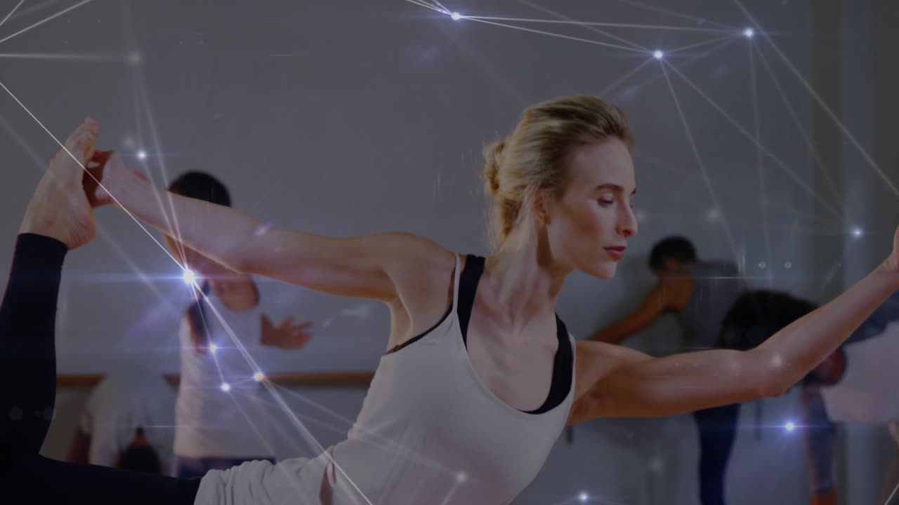 Camera focusing on leg, woman holding one-legged balance in barre class, overlay showing alignment