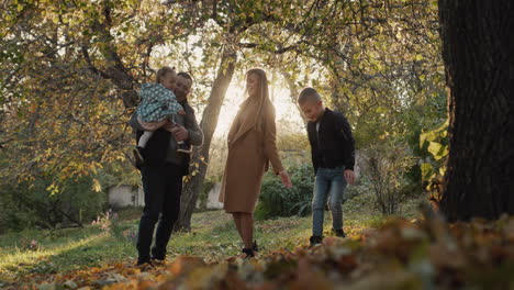 family with two children have fun in autumn park