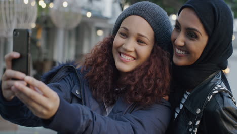 portrait young diverse women friends using smartphone taking selfie photo making faces enjoying relaxed fun happy girlfriends hang out in city together slow motion