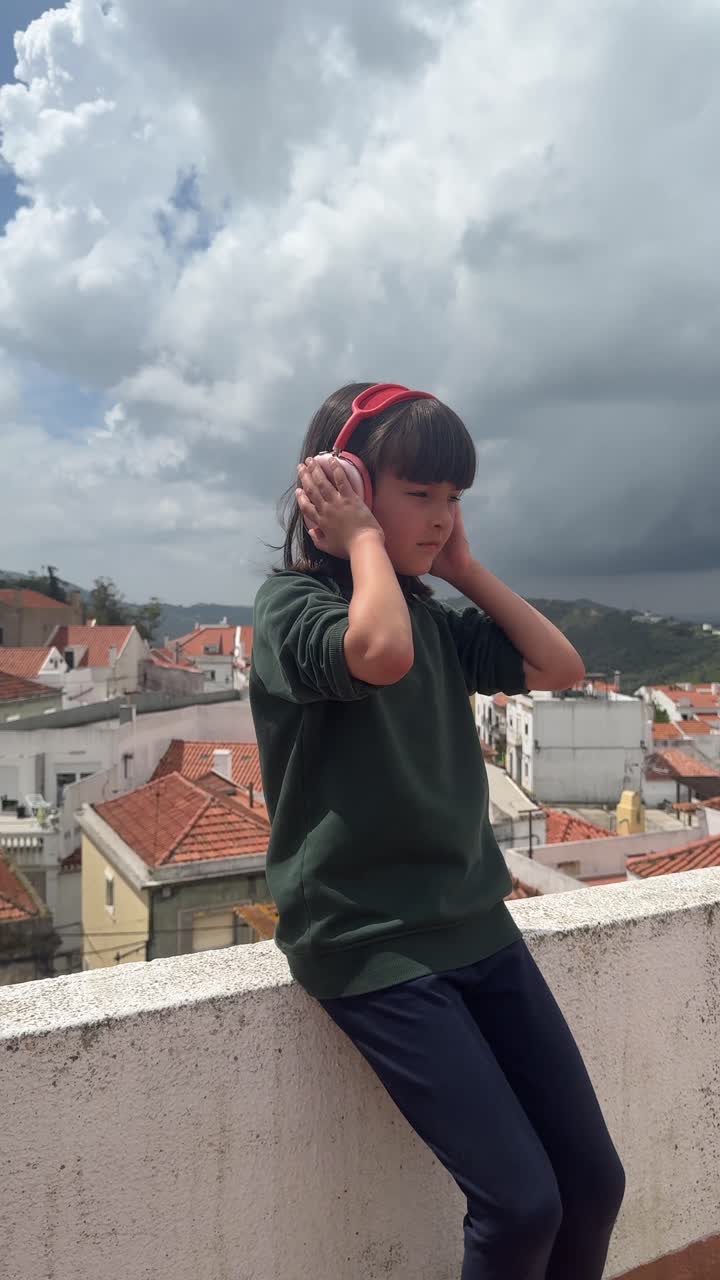 Girl with Headphones on a Rooftop