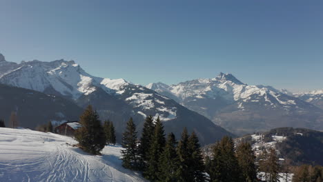 Aerial-reveal-of-beautiful-small-town-in-snow-covered-valley