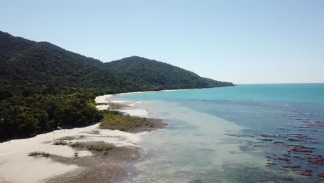 Aerial:-Drone-tracking-along-a-stunning-coastline-of-white-sand-beaches-and-turquoise-water-up-in-Cape-Tribulation,-Far-North-Queensland