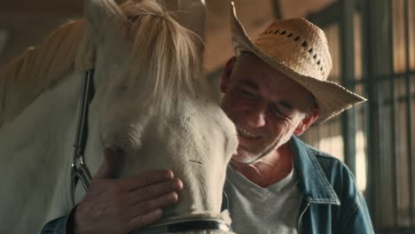 aged farmer hugging white horse