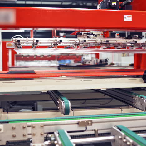 industrial robot working at solar pannels production factory,conveyor tracking controler of robotic hand. green energy concept.
