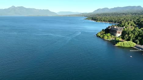 aerial dolly view of villarrica lake with luxurious hotel, chile