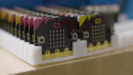 A plastic rack holds multiple single-board computers.