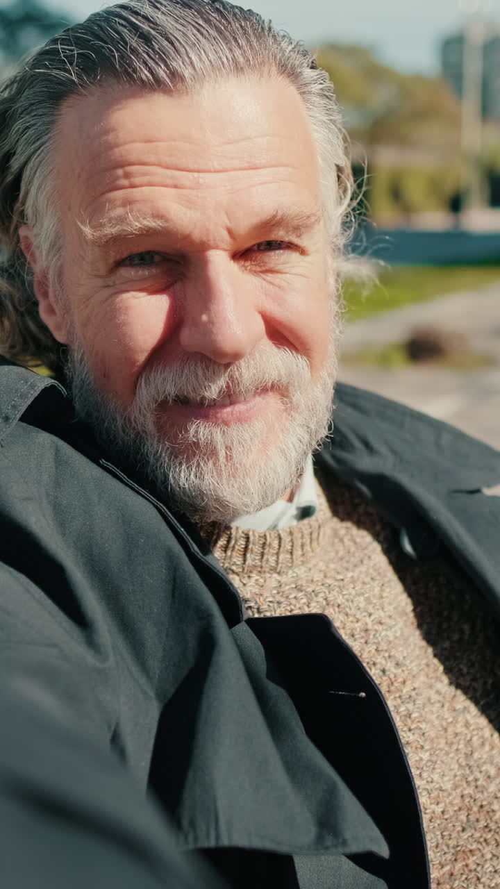 Happy Senior Man Taking a Selfie Video in the Park