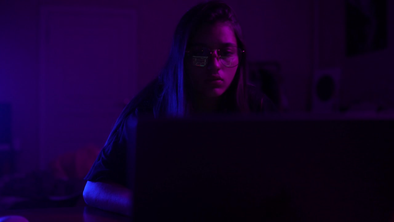 Teenager Working on Laptop at Night