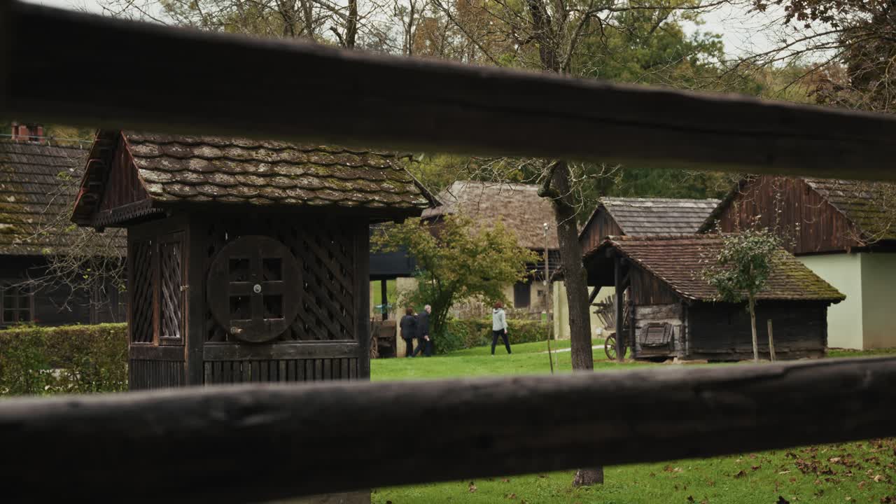 Traditional Croatian wooden houses in Kumrovec, surrounded by green fields and trees