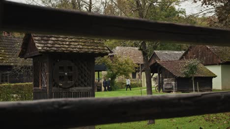 traditional croatian wooden houses in kumrovec, surrounded by green fields and trees