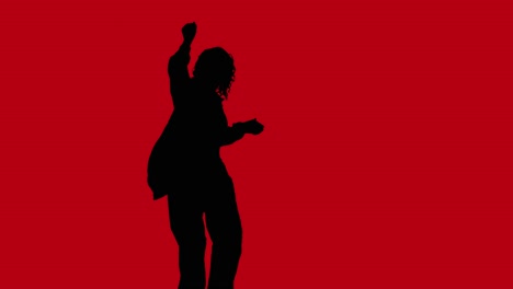 studio silhouette of woman dancing against changing coloured backgrounds