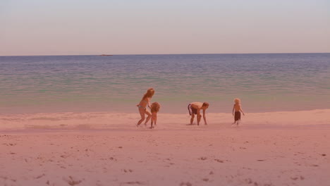 spots of light against caucasian family enjoying at the beach