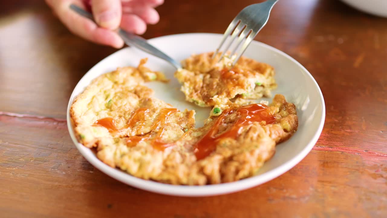 A spoon and fork serve an omelet dish