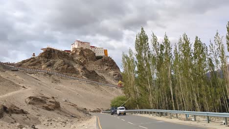 Pan-shot-of-a-road-passing-from-Thiksey-Monastery-in-Upper-Himalayas-of-Ladakh-India