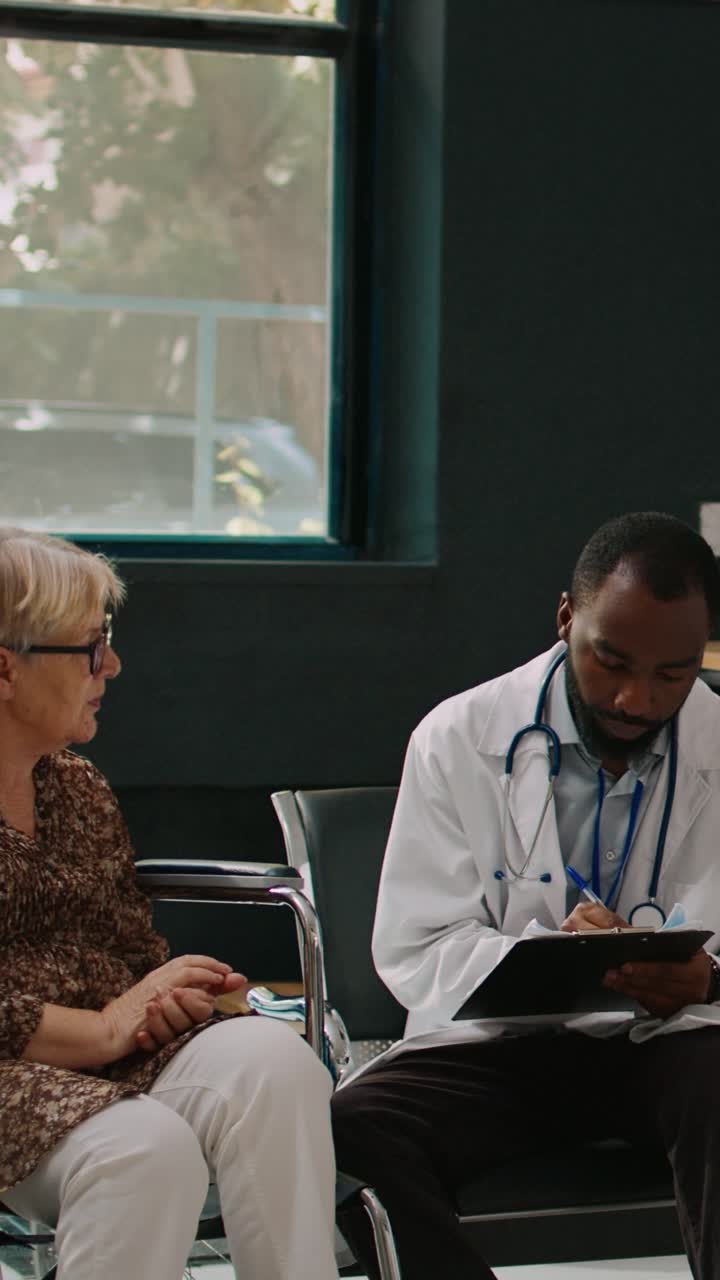 Doctor Consults with Elderly Patient in Hospital Waiting Room
