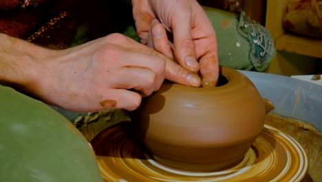 professional male potter working in workshop