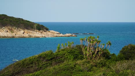 Pristine-paradise-island,-wild-shore-and-azure-sea-scenery,-Binh-Hung,-Vietnam