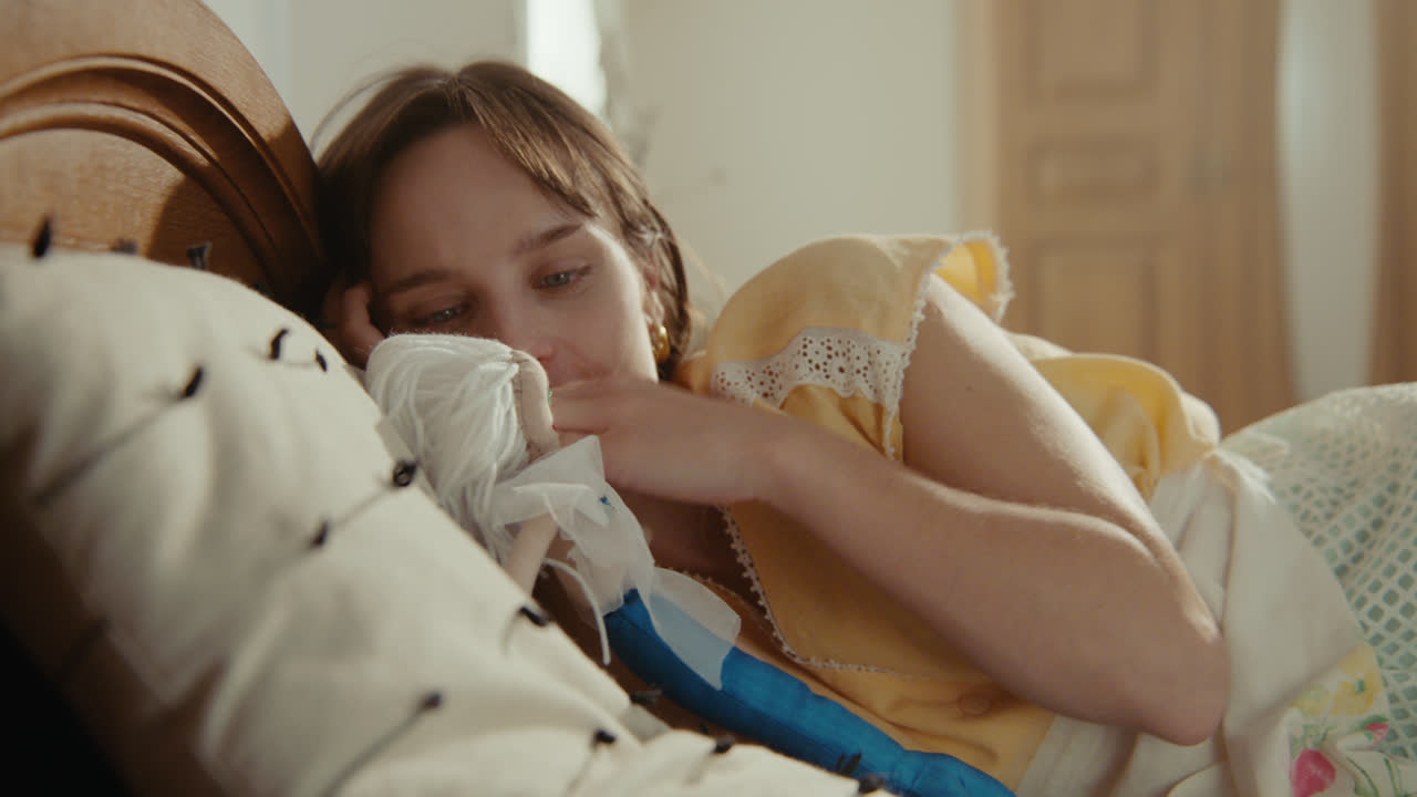 A girl playing with dolls in her room