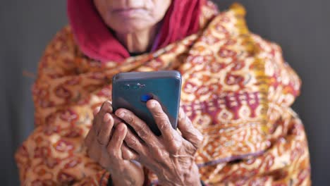 Senior-women-hand-using-smart-phone-close-up