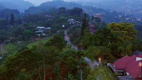 Forward-aerial-view-of-a-narrow-road-going-through-hills,-near-Dago-Pakar---Jl