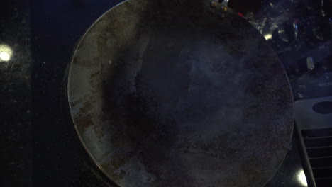 overhead view of a smoking flat pan