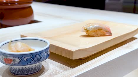 chef skillfully prepares sushi on wooden board