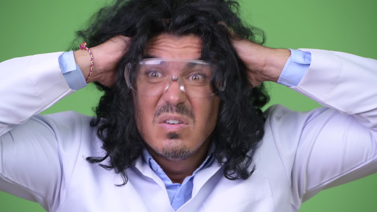 Crazy scientist wearing protective glasses and panicking
