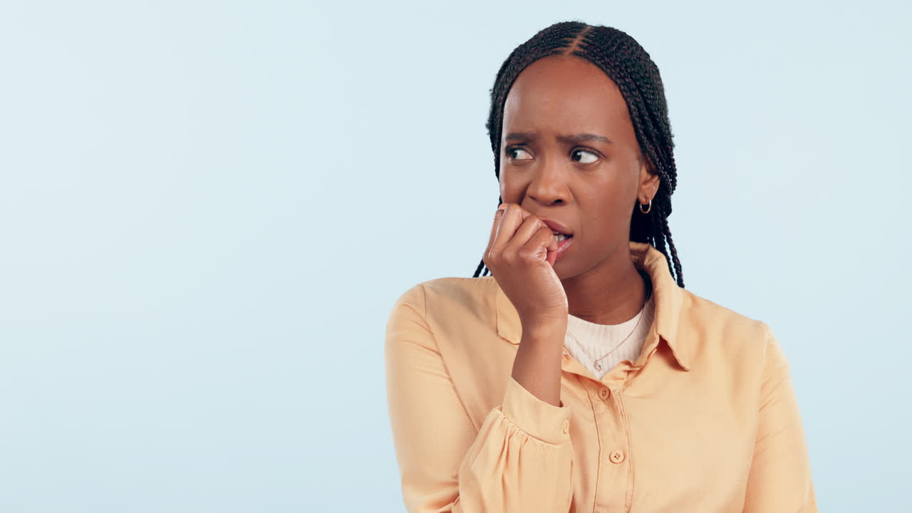 Woman, studio and biting nails with anxiety