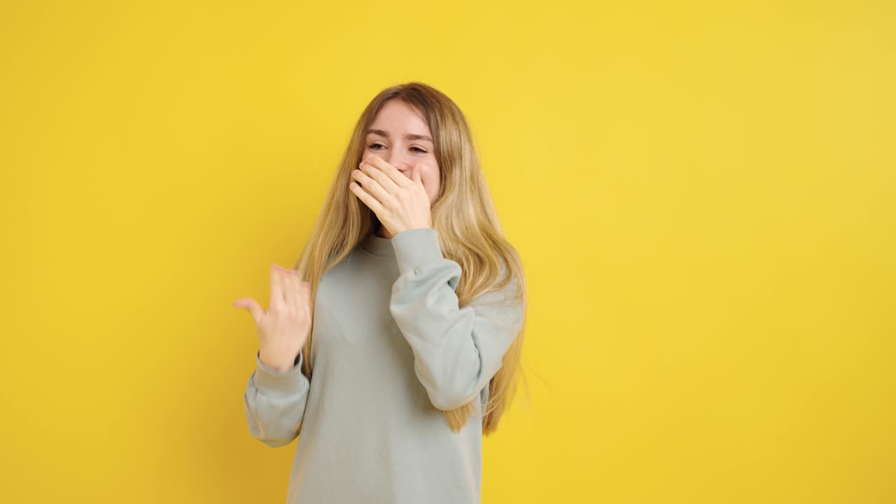 Joyful expressions of a woman against vibrant yellow background