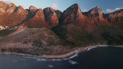 aerial view over victoria road in cape town, south africa - drone shot