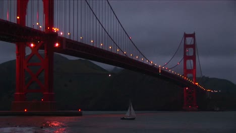 A-Wormseye-View-Of-The-Golden-Gate-Bridge-At-Night-With-Its-Lights-Reflecting-On-The-Water