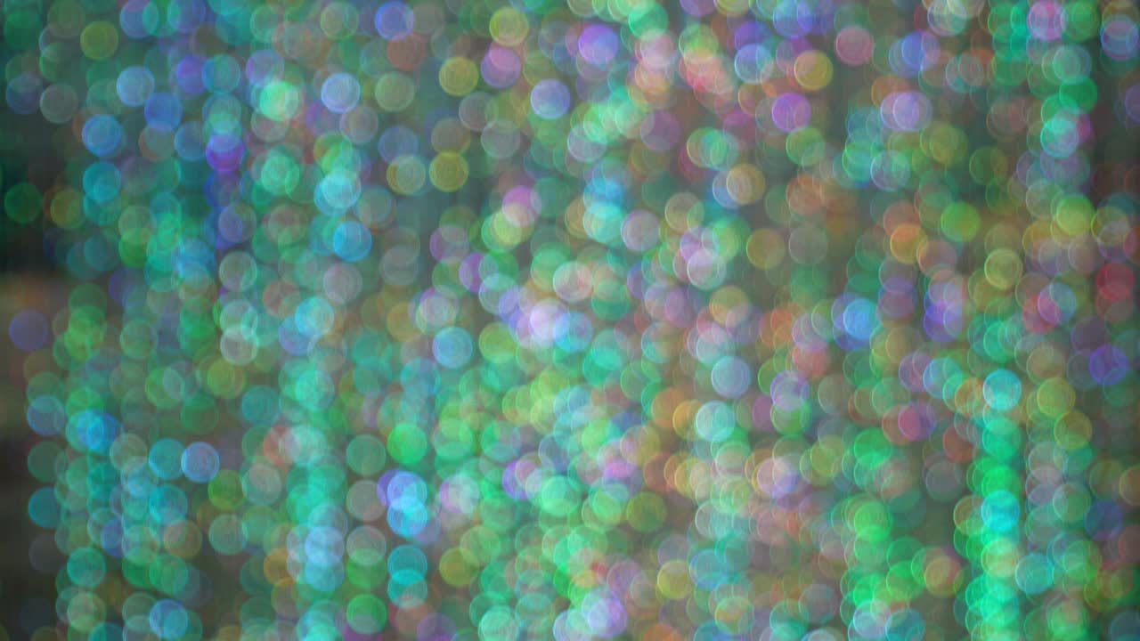 Blurry bokeh with bright colors from glittering materials and lights.