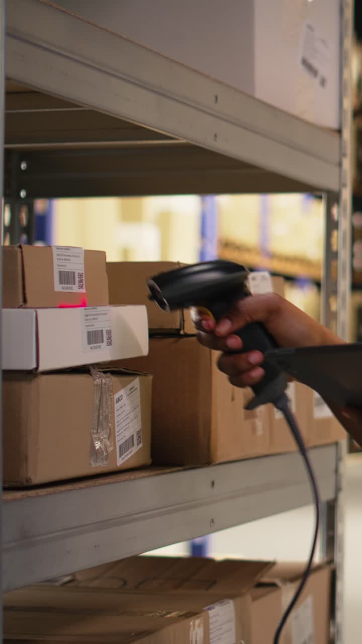 Vertical Video Black female worker using scanner checking airway bill numbers in inventory