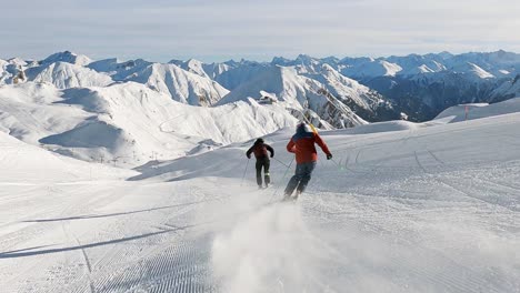 panorama skiing with two ski athletes in beautiful winter landscape high up in the mountains