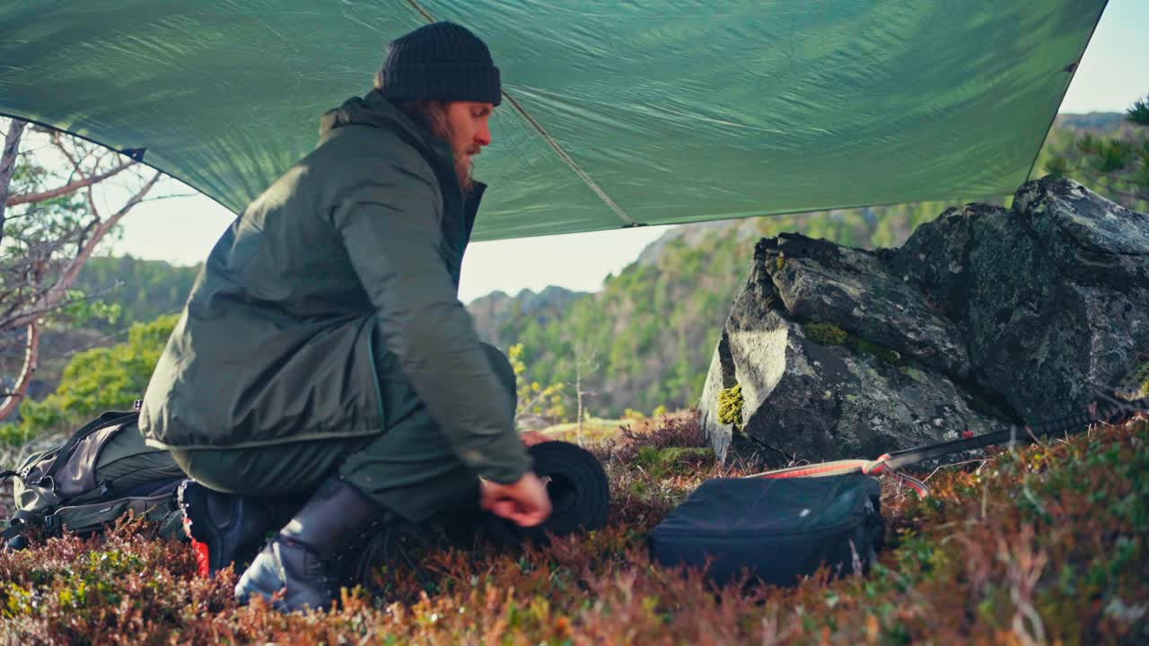 A Man and His Dog are Setting Up a Camping Tent by the Shores of Kattavatnet Lake in Roan, Trøndelag, Norway - Close Up