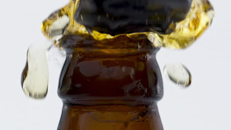 fresh beer fontaining bottle in super slow motion close up. refreshing beverage.