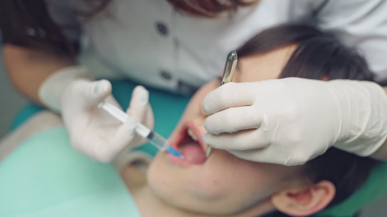 Dentist is treating a patient in a modern dental office.